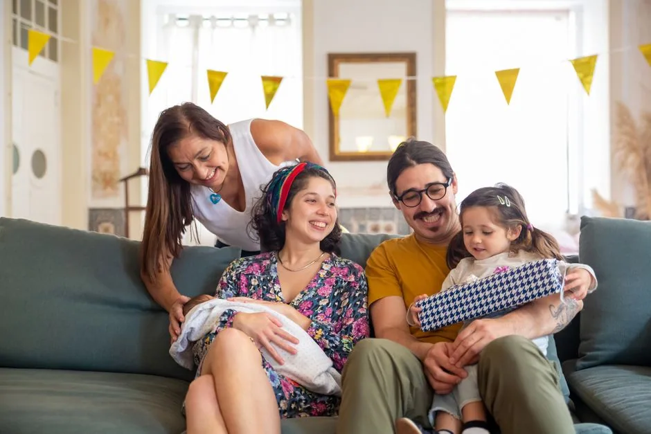 Familie sitzt gemeinsam im Wohnzimmer und verbringt wertvolle Zeit zusammen